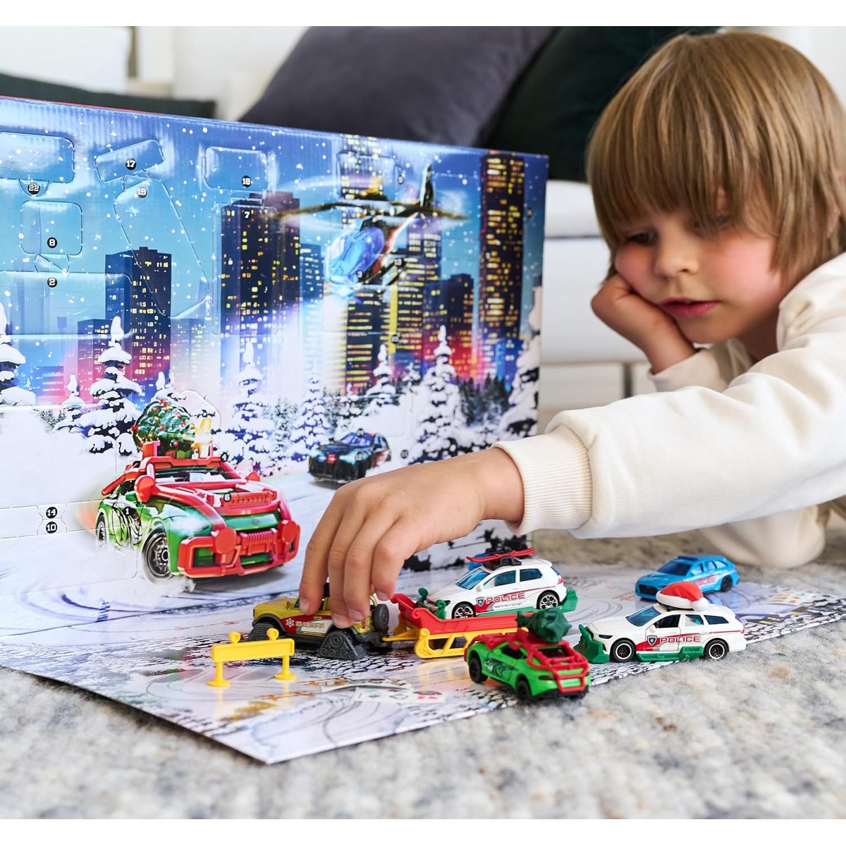 Child playing with the cars on the calendar